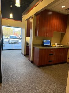 Work area with wooden cabinets, countertop space, and a computer